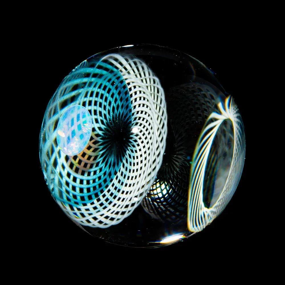Hand-blown glass marble with intricate blue and white spiral patterns and opal detail