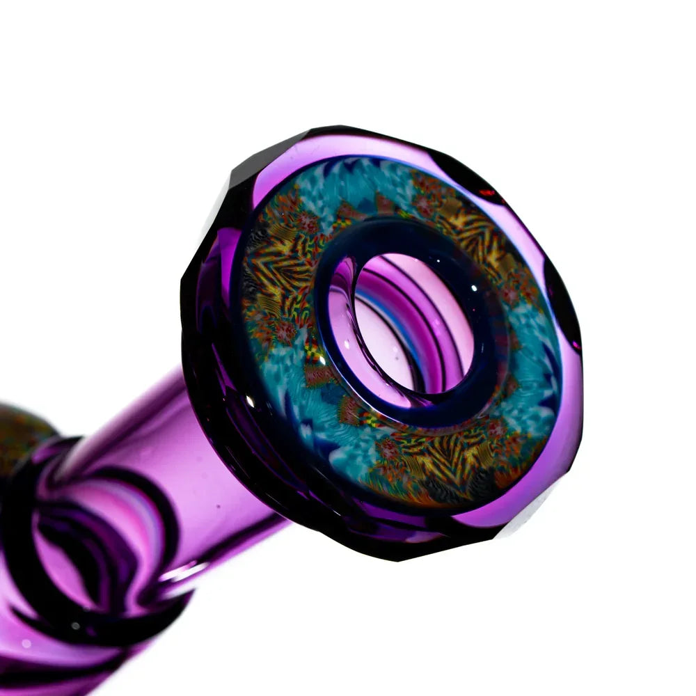 Purple glass water pipe base with intricate colorful pattern, close-up