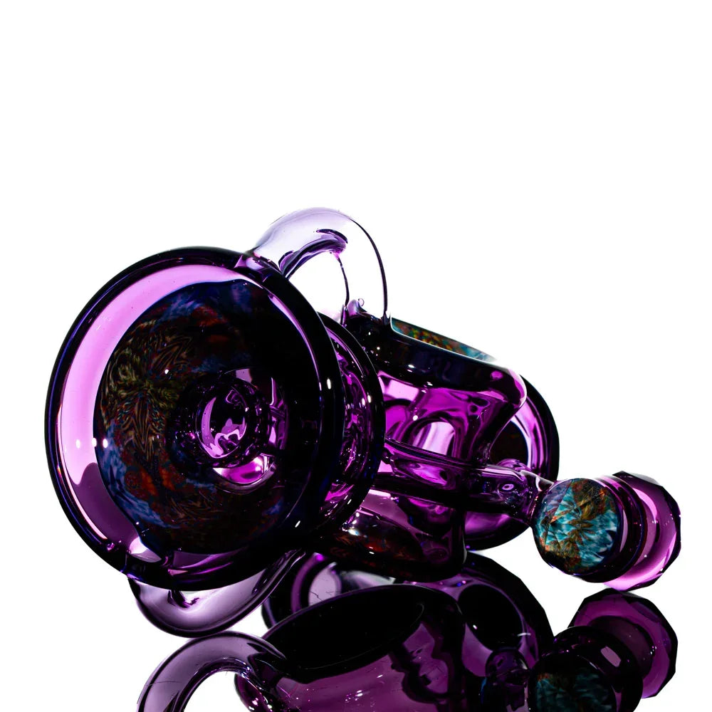 Purple heady glass art pipe with intricate marbled patterns on a reflective surface