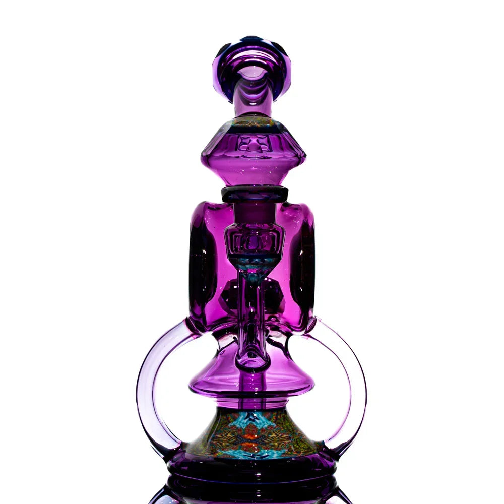 Colorful purple heady glass water pipe with intricate design on a white background