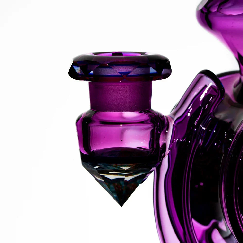 Close-up of a purple glass bong detail with diamond-cut accent, heady glass smoking accessory