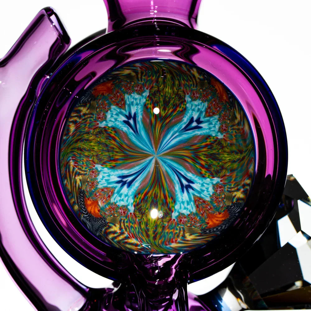 Close-up of a purple glass pipe featuring a vibrant kaleidoscope pattern marble.