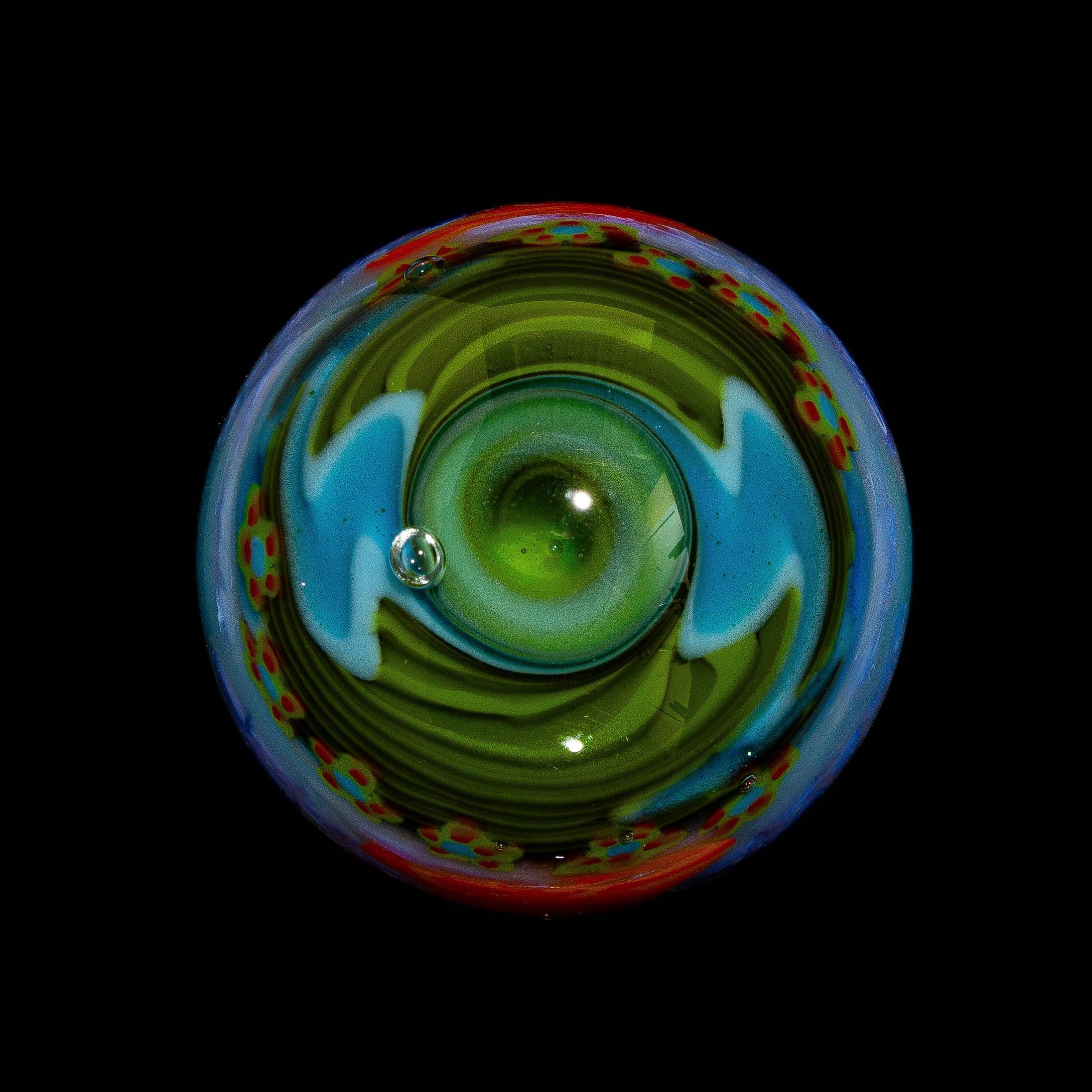 Colorful abstract glass art marble with swirling green, blue, and red patterns on black background.