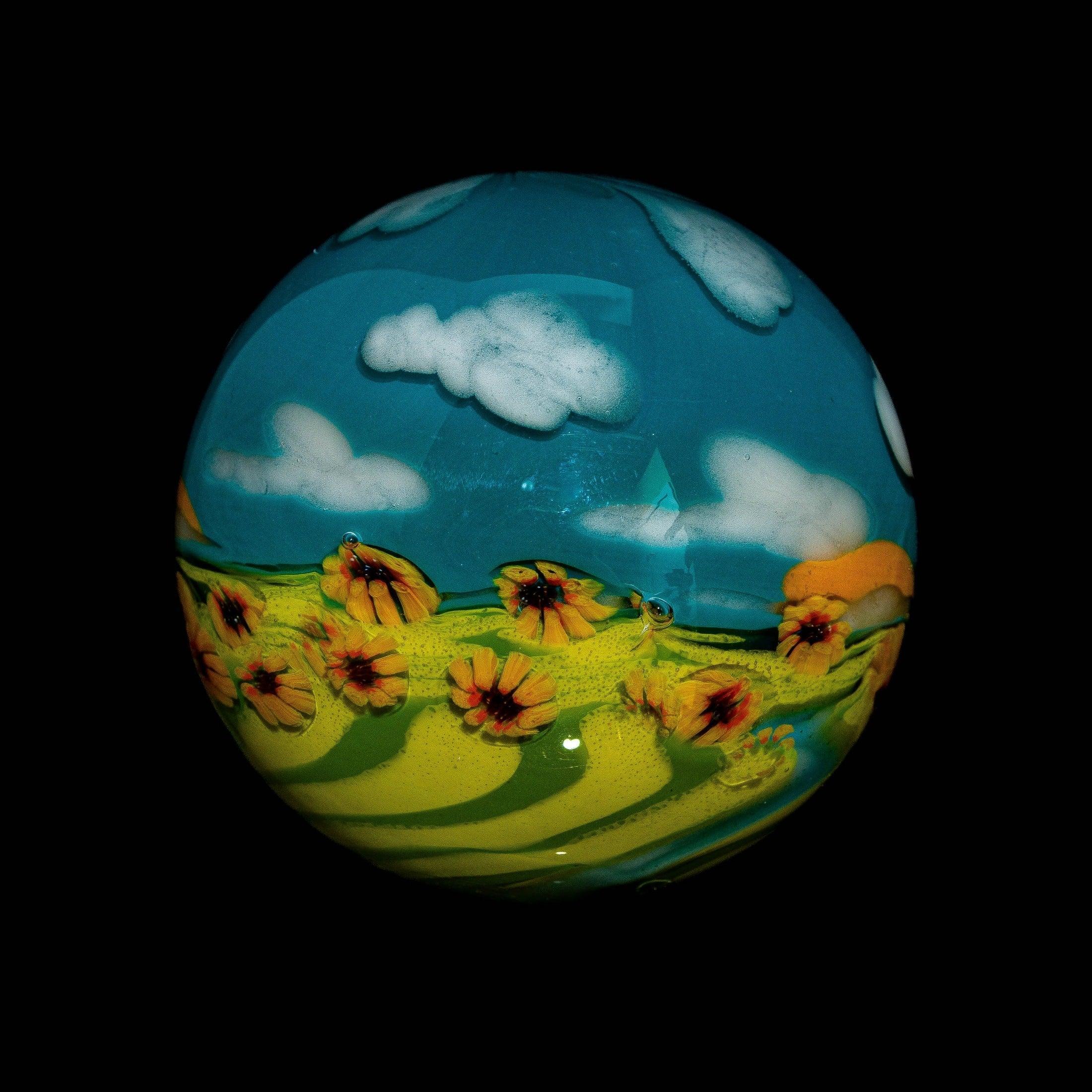 Art glass sphere with sunflower field and blue sky with clouds design