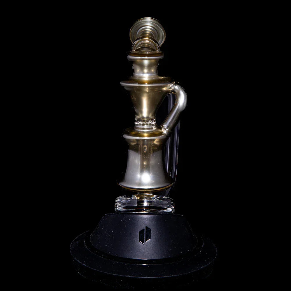 Gold and clear glass recycler water pipe with sculpted design on black background