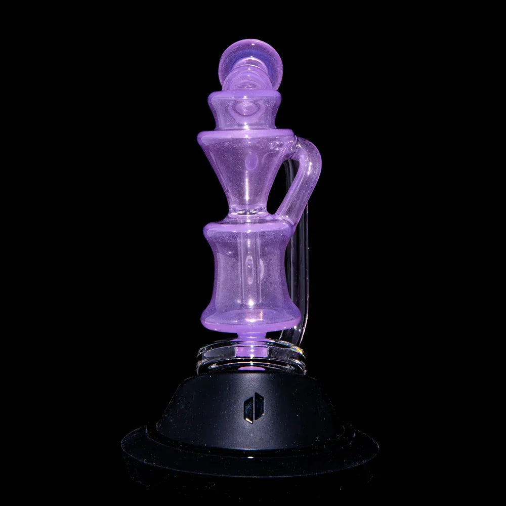 Translucent purple glass recycler water pipe on black background