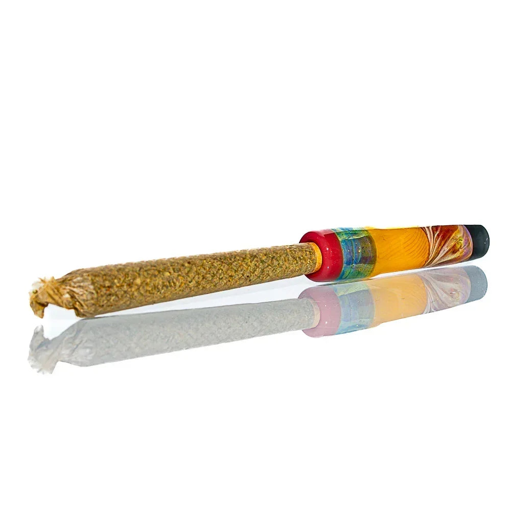 Pre-rolled cone with colorful glass joint tip on reflective white surface