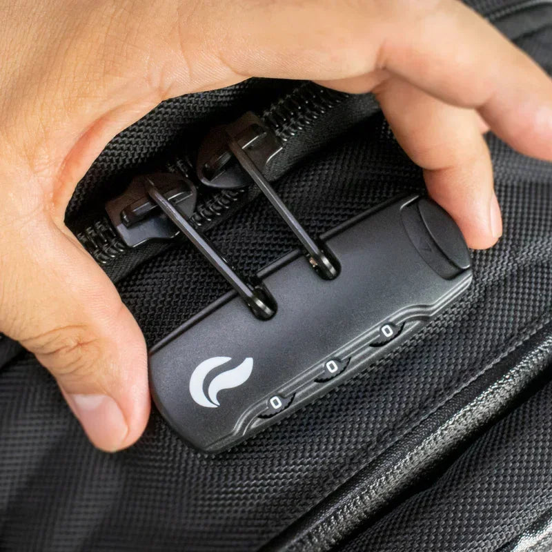 Hand securing black backpack with combination lock and double zipper pulls