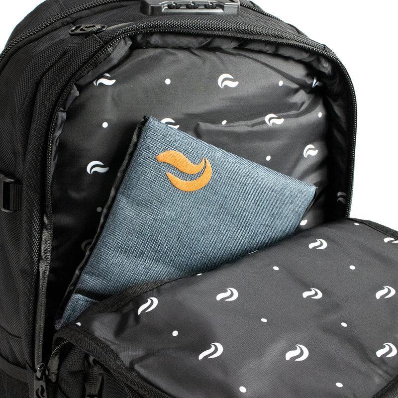 Black backpack with patterned interior and padded laptop sleeve, open front pocket
