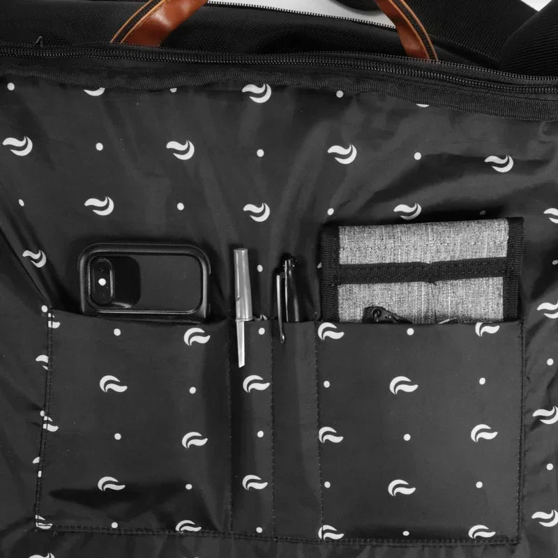 Black bag interior with patterned lining, organized pockets holding a phone, pens, and wallet