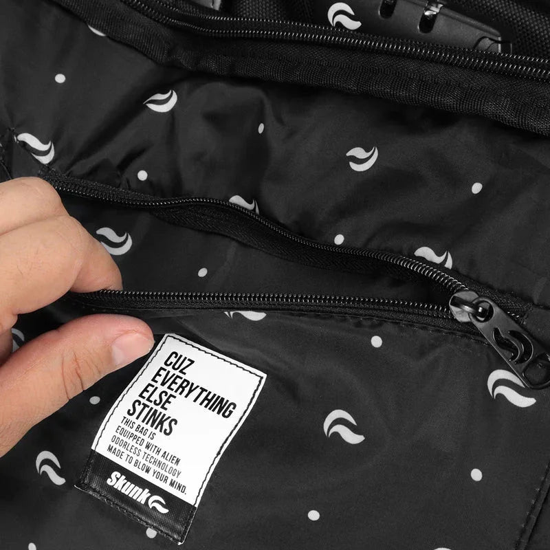 Closeup of black backpack interior with stash pockets and odor-proof tech label