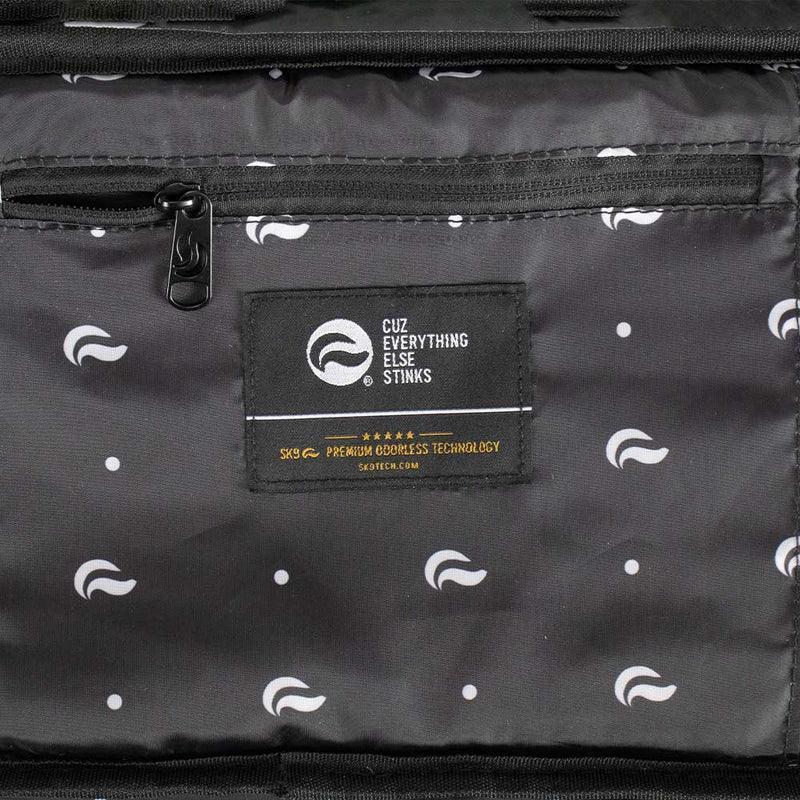 Close-up of black odor-proof bag interior with white pattern, zip pocket, and SK9 label.