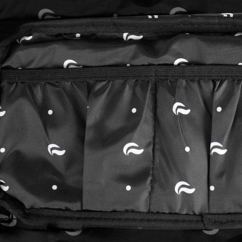 Black fabric bag interior with white abstract dot and swirl pattern, elastic pocket compartments