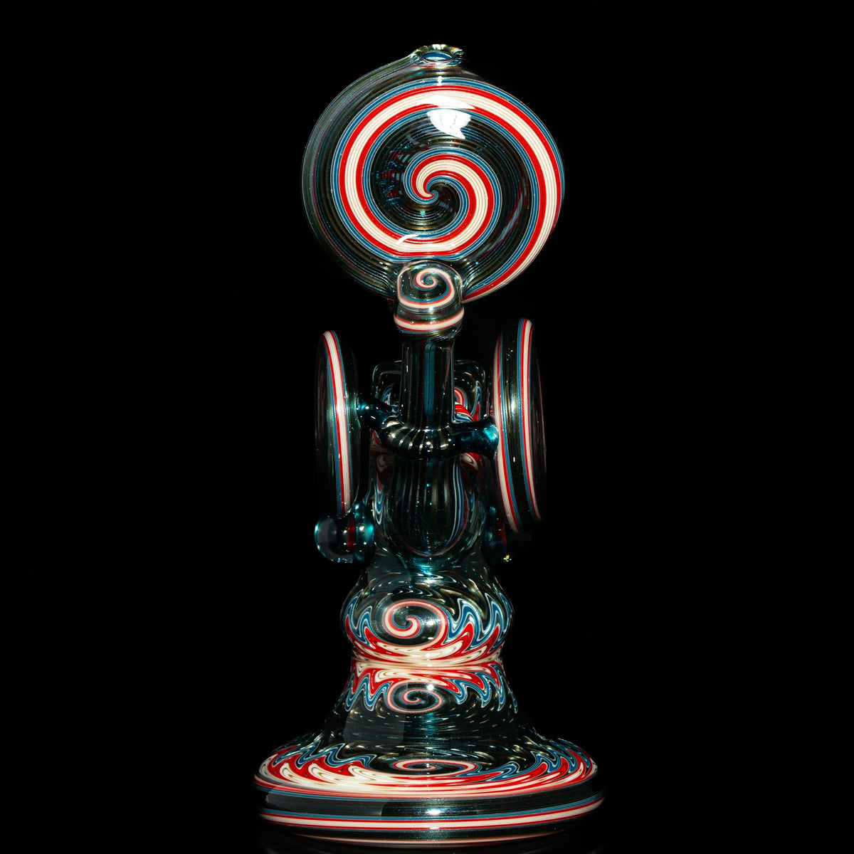 Heady glass water pipe with red, white, and blue spiral designs on a black background