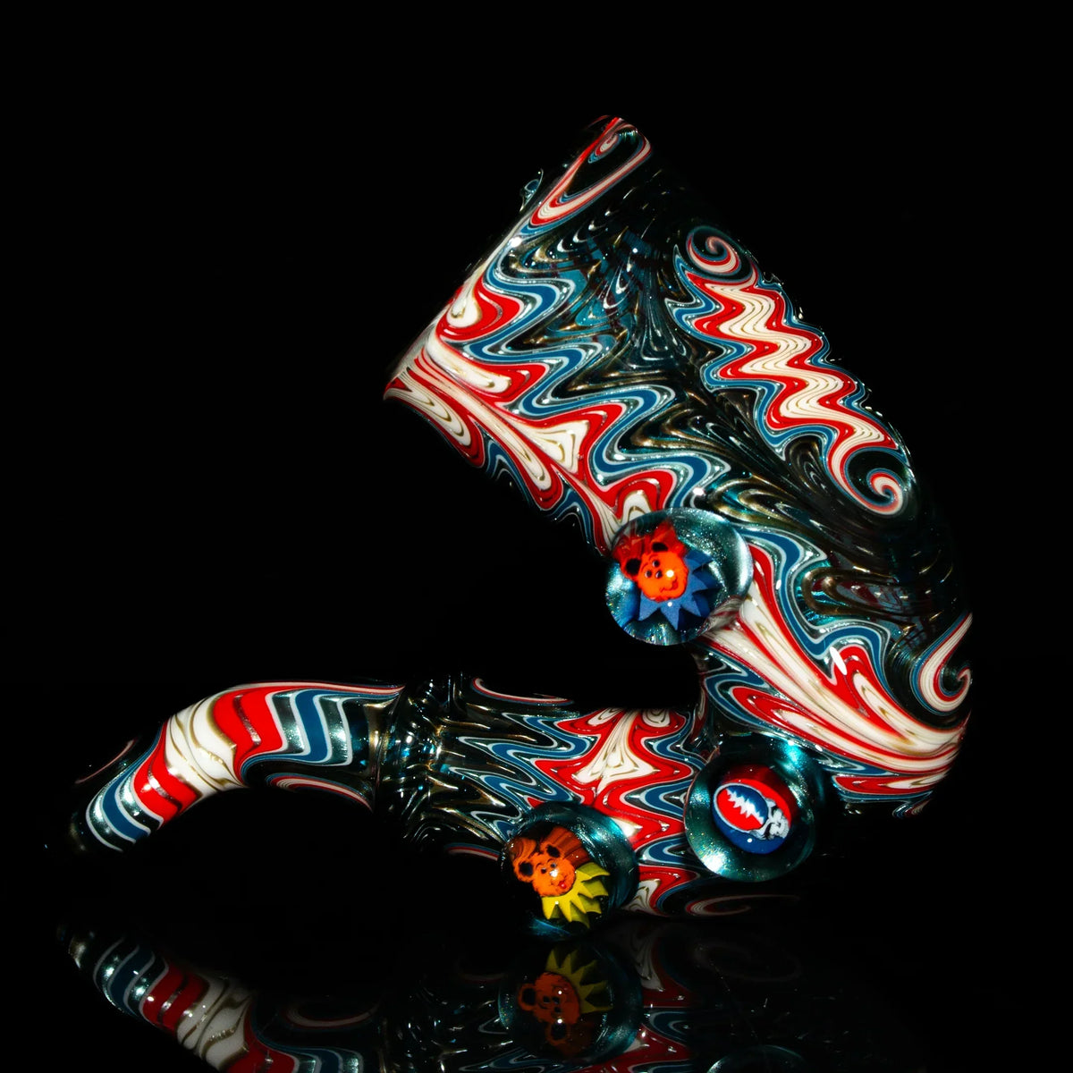 Colorful heady glass pipe with red, blue, and white swirl patterns and decorative accents