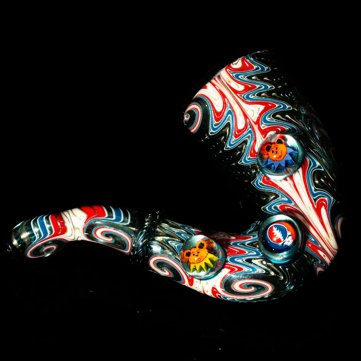 Heady glass hand pipe with red, white, and blue swirl patterns and decorative marbles