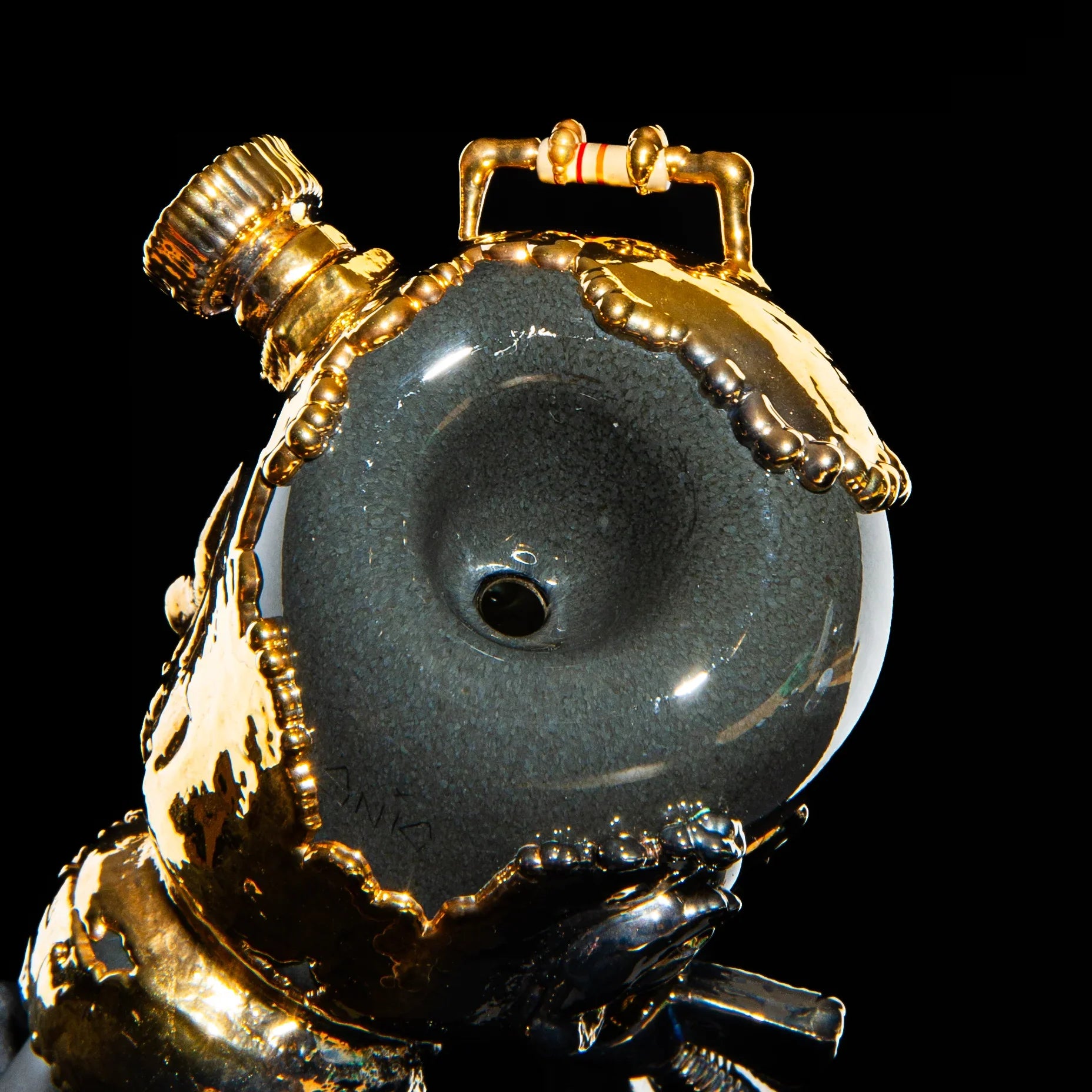 18mm glass slide with metallic gold details and gas mask-inspired design on black background