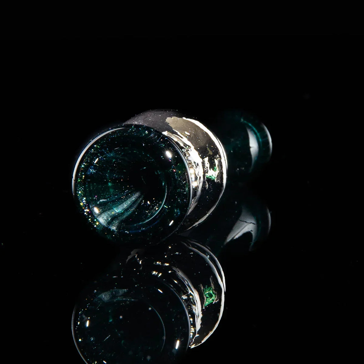 Black glass chillum with shimmering sparkles and metallic accents on a reflective surface