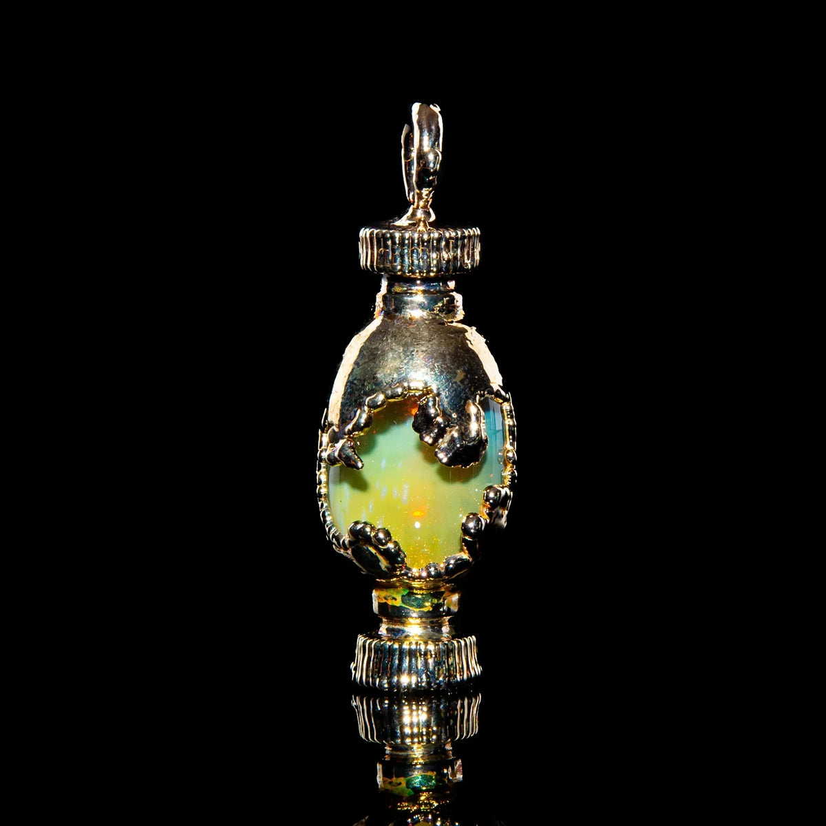 Silver opal pendant with ornate details on black background