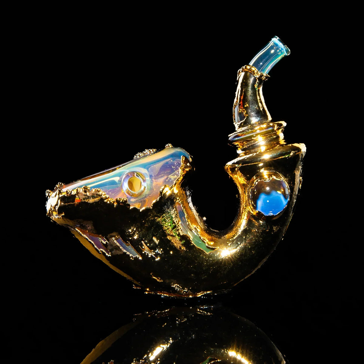 Gold sherlock glass pipe with iridescent accents on reflective black background