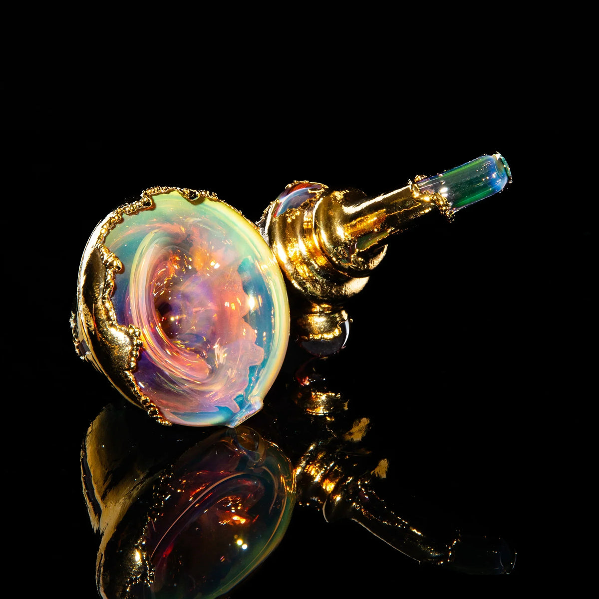 Gold sherlock hand pipe with iridescent glass and ornate details on black background