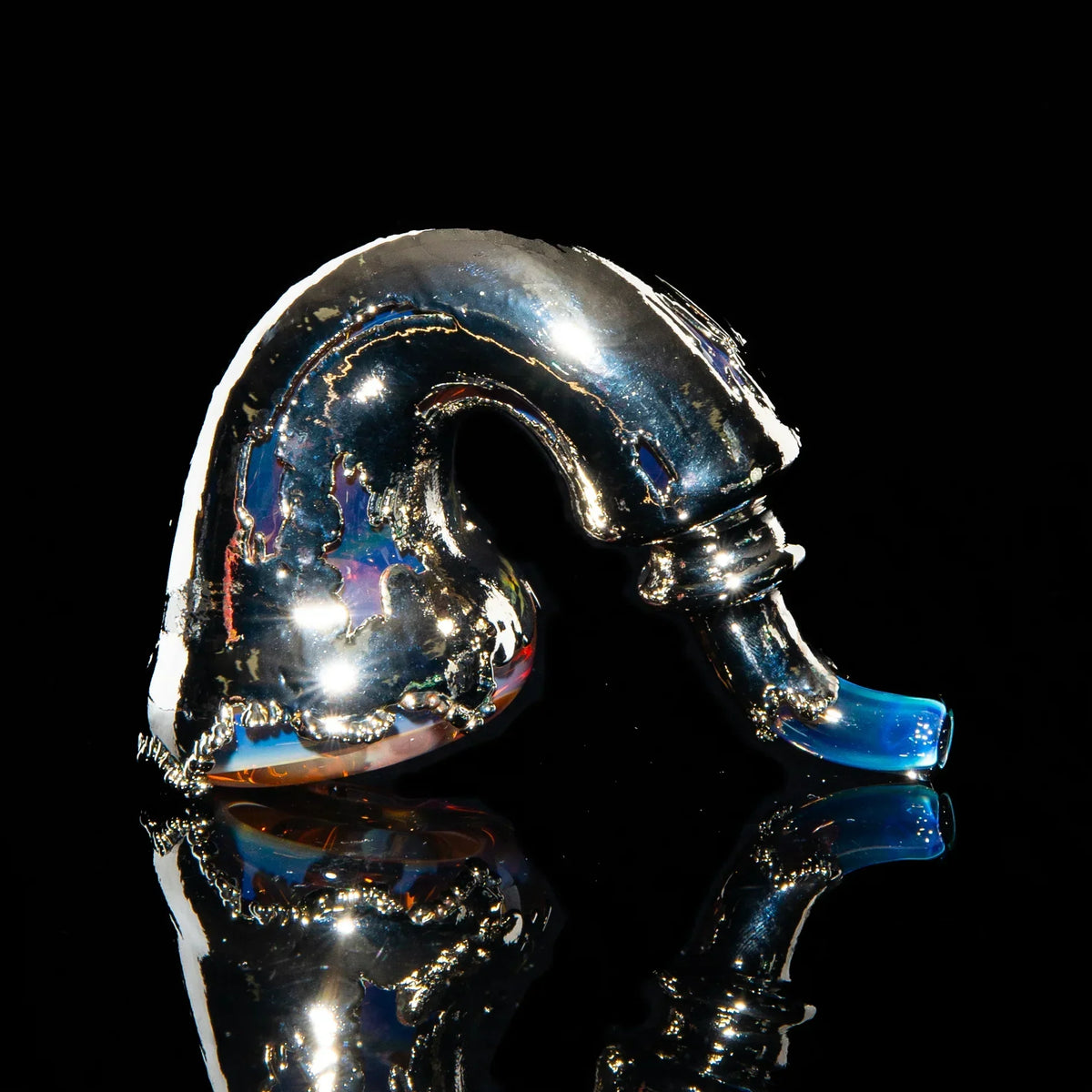 Silver metallic glass Sherlock pipe with blue mouthpiece on black reflective background
