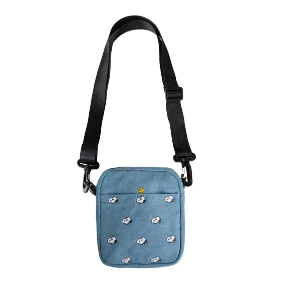 Blue crossbody bag with embroidered Snoopy faces and black adjustable strap