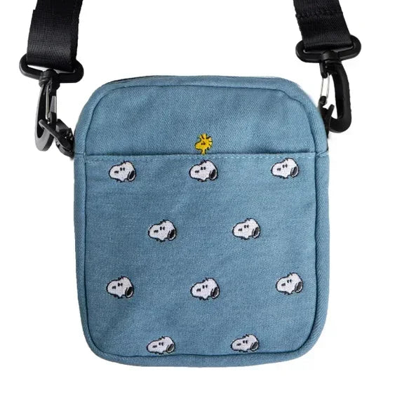 Blue canvas crossbody bag with Snoopy and Woodstock embroidery, adjustable black strap