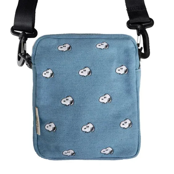 Blue crossbody bag with embroidered cartoon dog faces and black adjustable strap