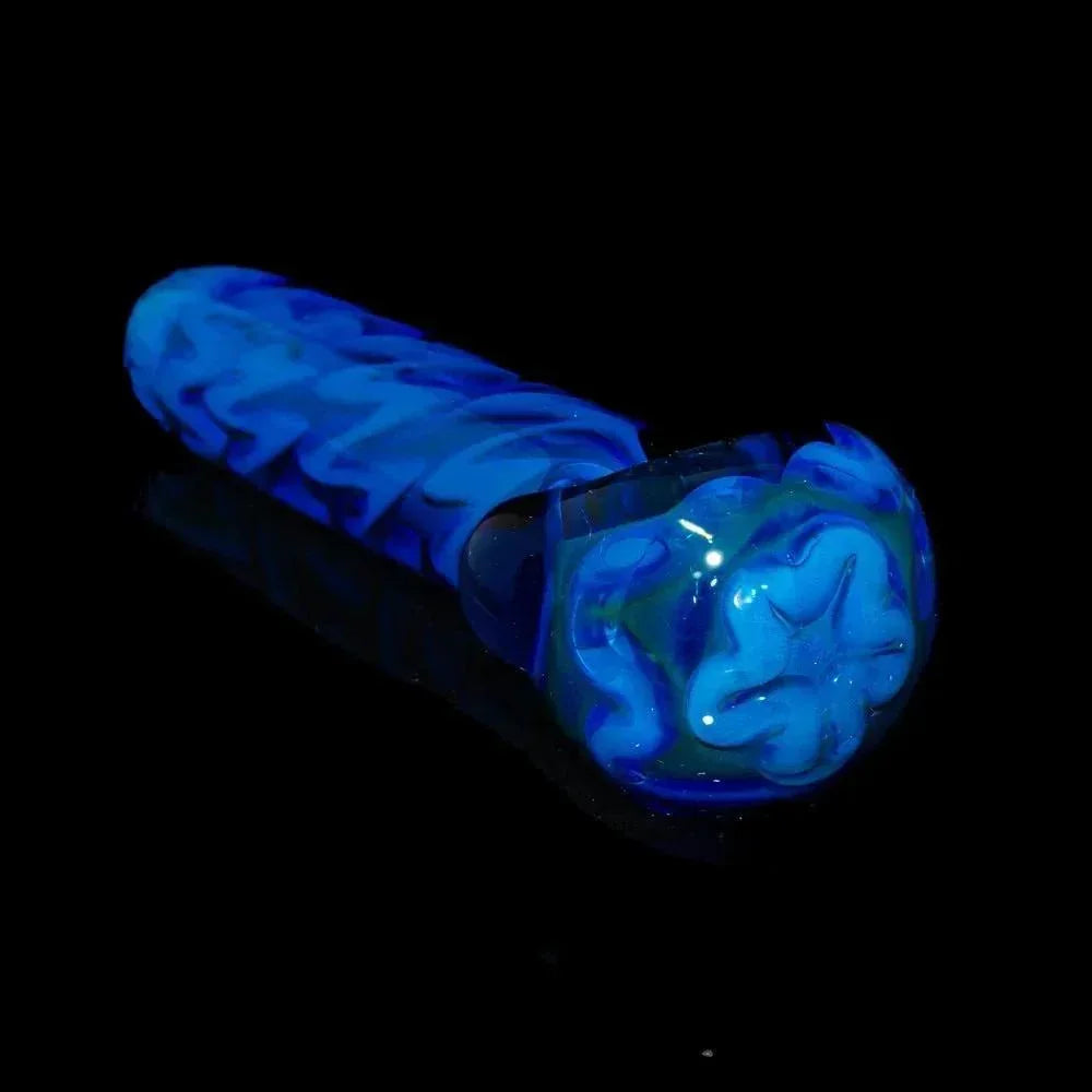 Blue inside out glass spoon pipe with intricate swirl design on a black background
