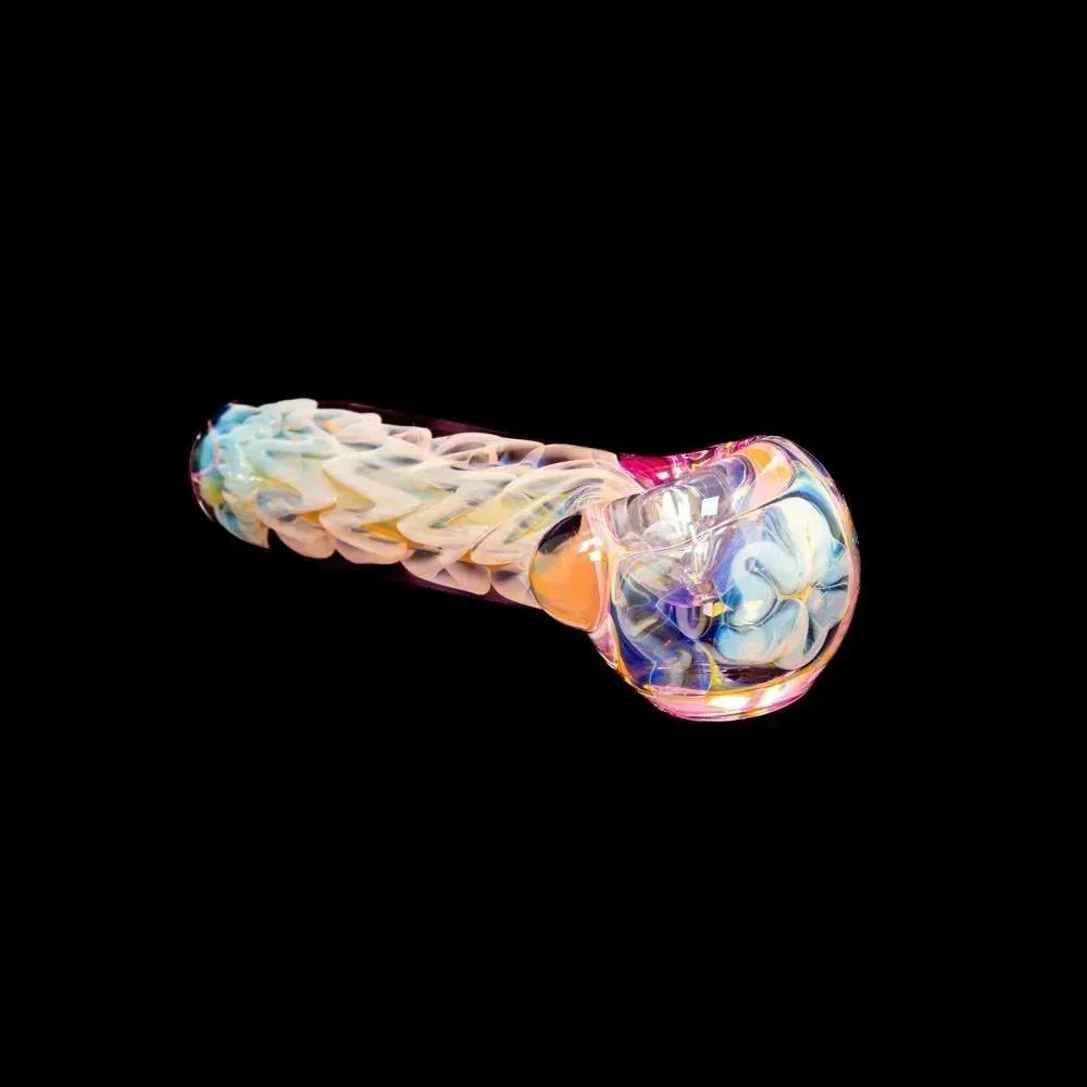 Pink inside-out glass spoon pipe with colorful swirling design on black background