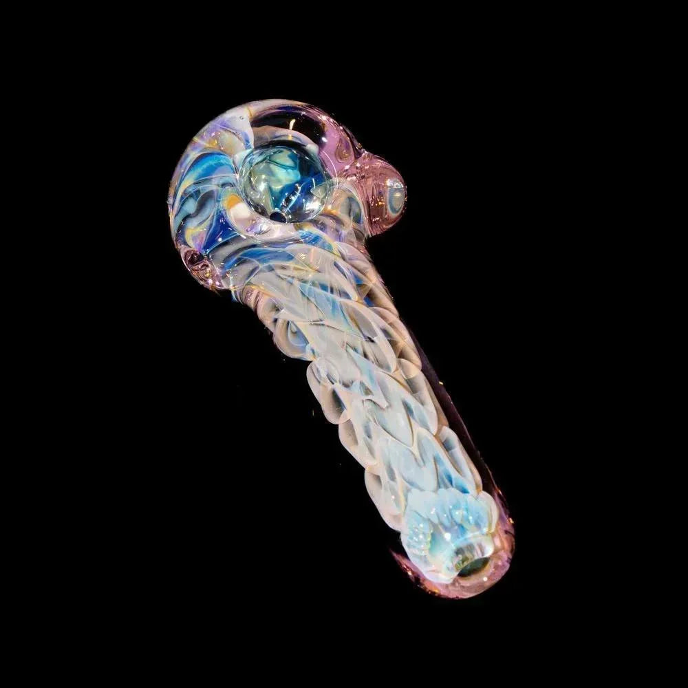 Handcrafted pink glass spoon pipe with intricate inside-out color patterns on black background