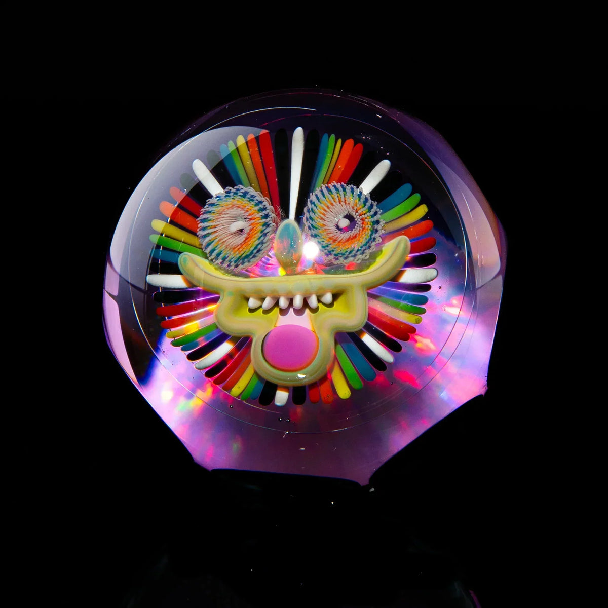 Colorful glass marble with a fun, psychedelic face design and intricate patterns