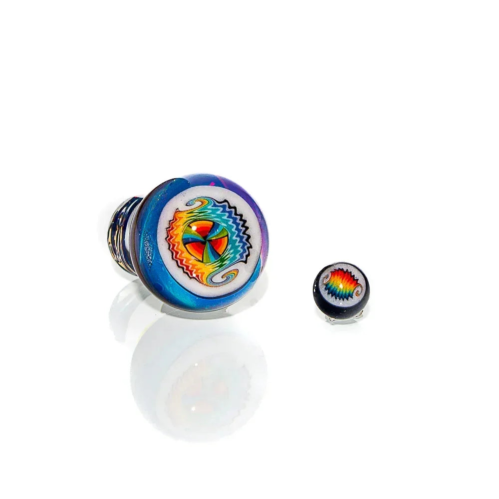 Colorful glass carb cap and matching dab pearl with intricate rainbow wigwag design on white background.
