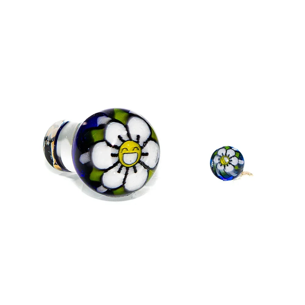 Hand-blown glass cap with a cobalt base and a happy flower design, shown front and side view.