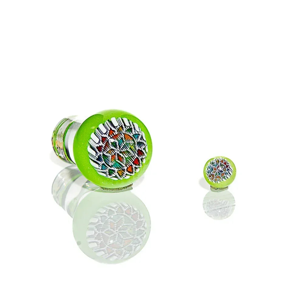 Green glass carb cap with mandala pattern and matching marble on white background