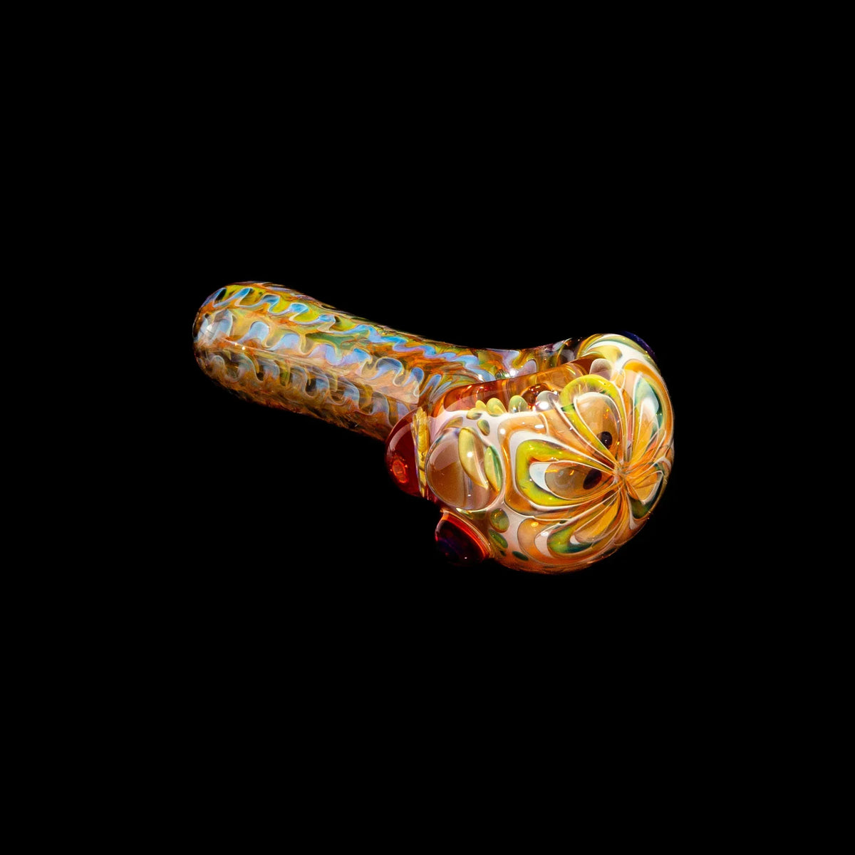 Handcrafted glass spoon pipe with honeycomb and colorful fume wrap design on black background