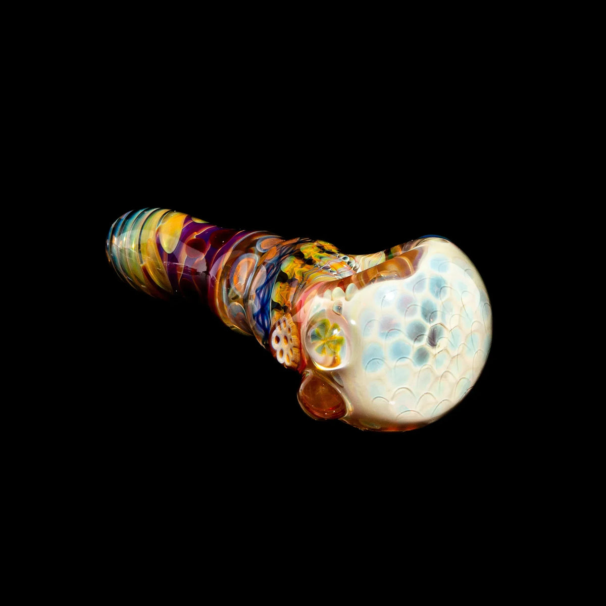 Colorful glass hand pipe with honeycomb and ribbon cane design on a black background