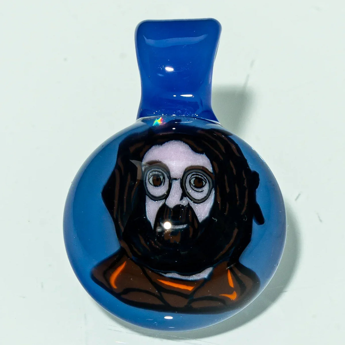 Blue glass pendant featuring a detailed portrait of a bearded man with glasses.