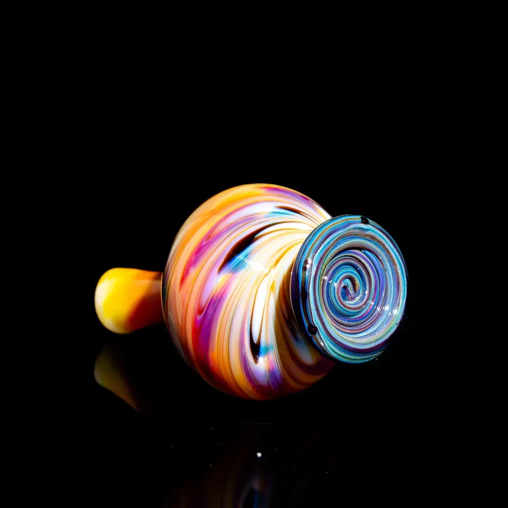 Colorful hand-blown glass pipe with vibrant swirling patterns on a black background