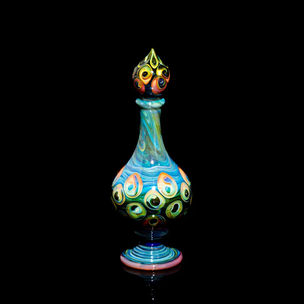 Colorful hand-blown glass art bottle with peacock-inspired patterns on a black background