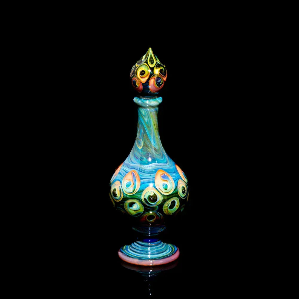 Colorful hand-blown glass art bottle with peacock-inspired patterns on a black background