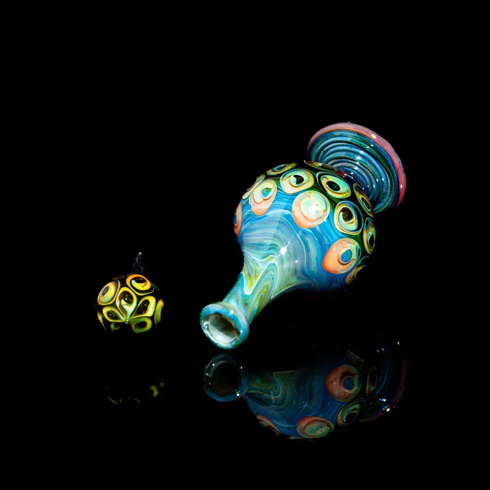 Colorful hand-blown glass art pipe and matching carb cap with vibrant swirling patterns