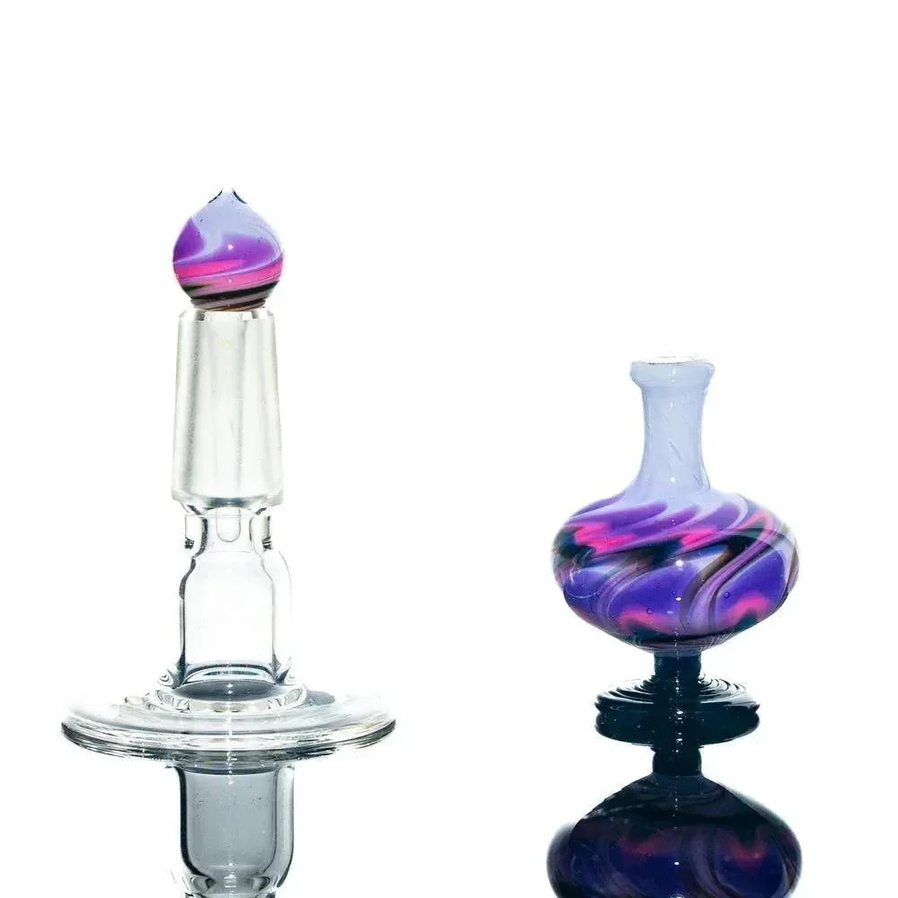 Purple and pink swirled glass perfume jar with matching stopper, displayed on white background