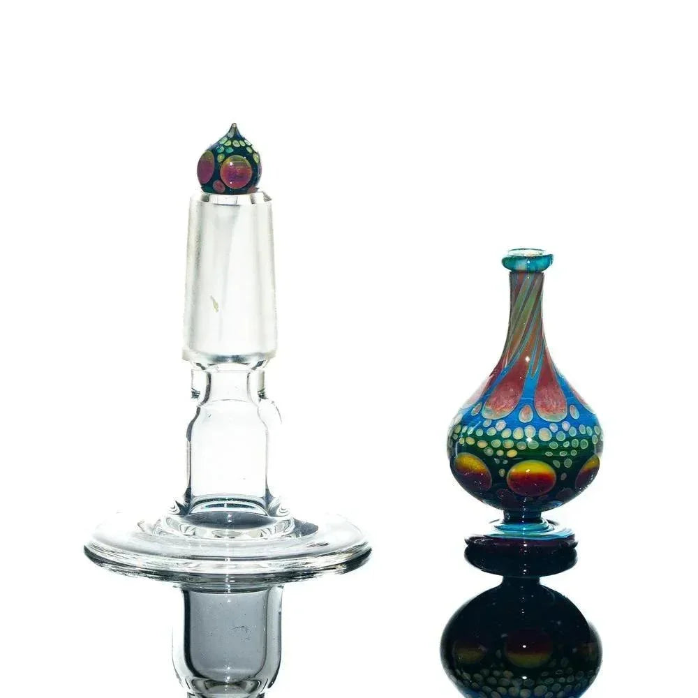 Colorful glass perfume jar and clear glass stopper on white background, art glass accessory