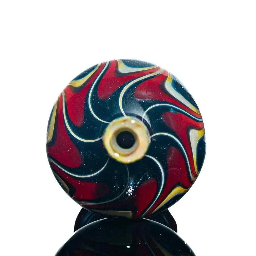 Hand-blown glass jar with red, yellow, and black swirl pattern, circular top view