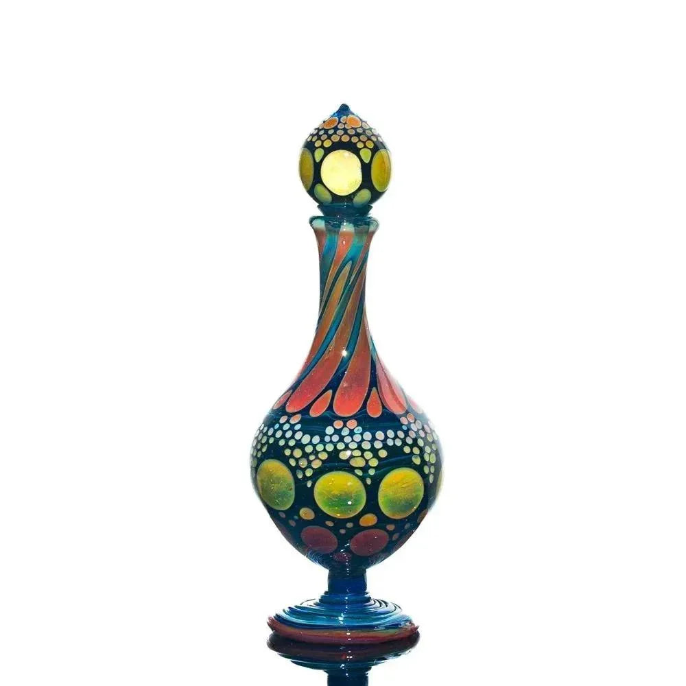 Hand-blown glass perfume jar with colorful dot and swirl patterns on a white background.