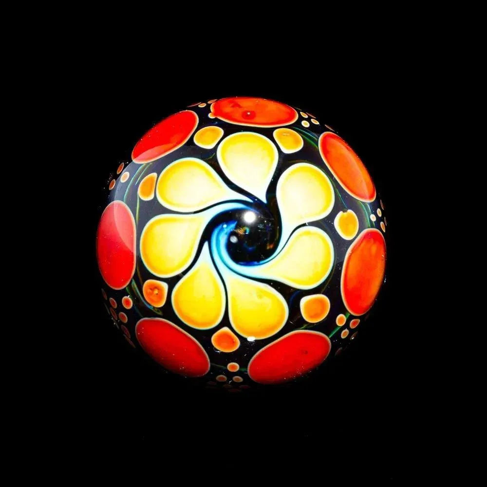 Handcrafted orange ombre hobnail marble with yellow and red glass swirl design on black background