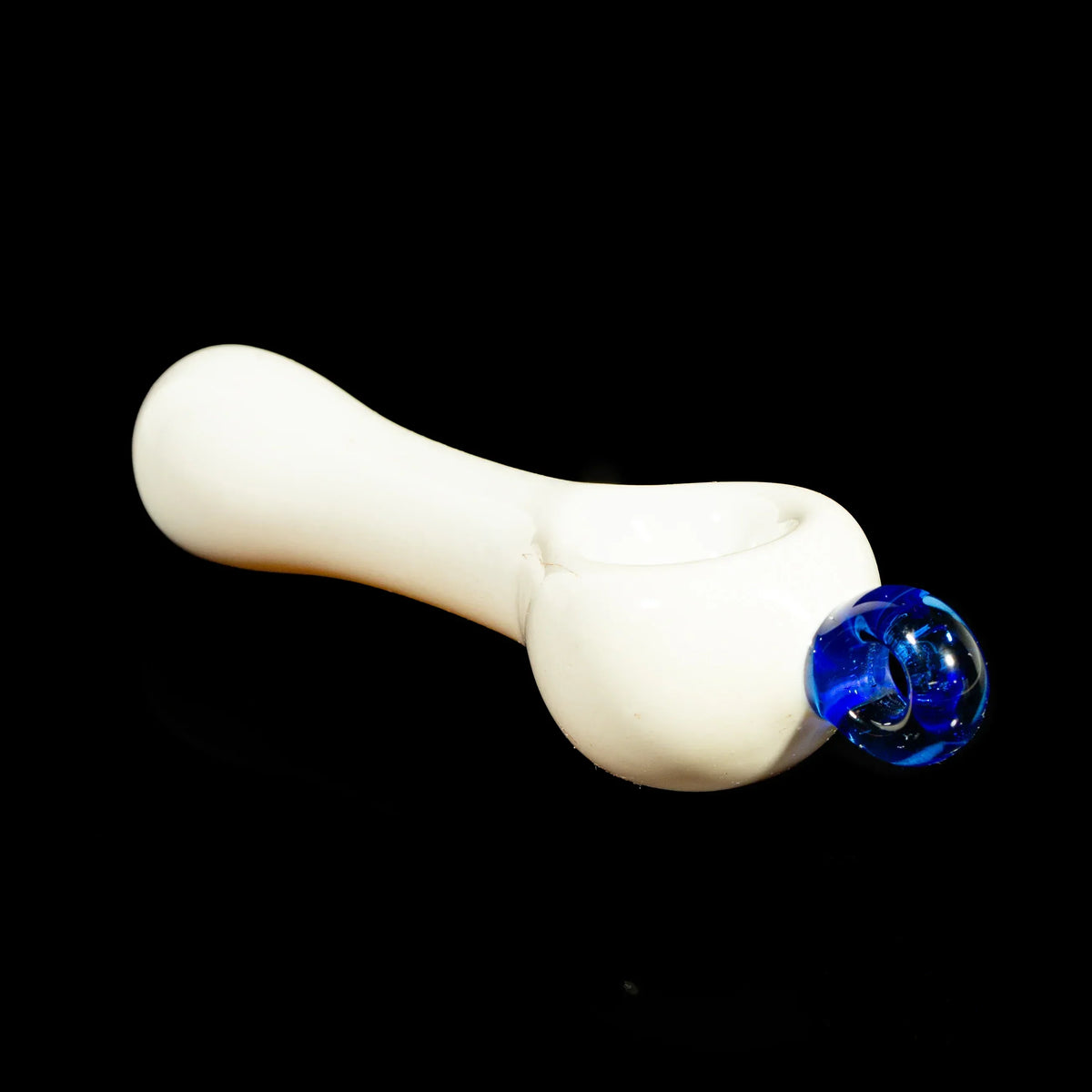 White glass spoon pipe with blue glass marble detail on black background