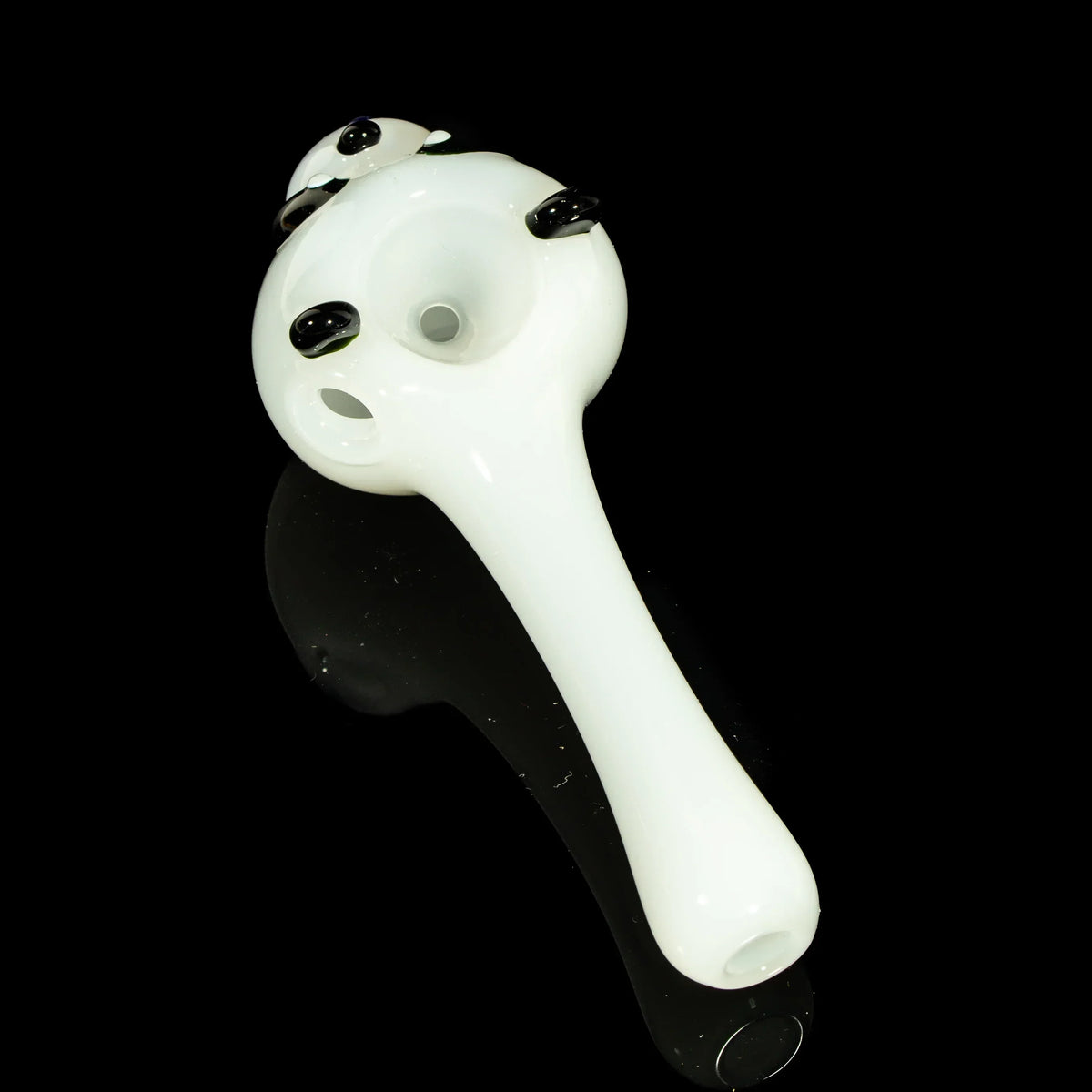 White glass spoon pipe with panda bear design on black background